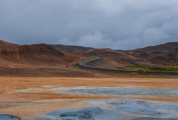 Hverir geothermal area in North Iceland. dy geysers and sulfur field. Orange mountains Iceland.