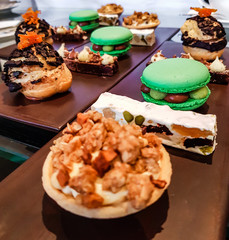 Luxury afternoon tea with macaroons and delicious desserts like nougat and healthy nuts. Close up of a popular high tea in England. 