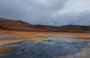 Hverir geothermal area in North Iceland. dy geysers and sulfur field. Orange mountains Iceland.