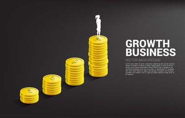 Silhouette of businesswoman standing on top of growth graph with stack of coin. Concept of success investment and growth in business