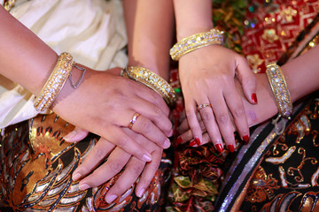 Bridal couple hands with Javanese style accessories in traditional Javanese wedding.