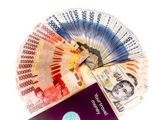 Indonesian rupiah mixed with Singapore dollar in cash currency isolated on white background. Money in high notes.