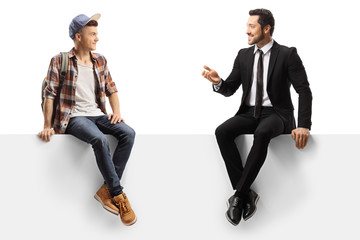 Businessman talking to a male student and sitting on a panel
