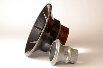 A pair of simple optics: lens and condenser. The silvery lens and optical condenser from old 35-mm enlarger (sepia slightly tinted)