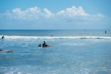Fototapeta na wymiar Paralyzed surfer paddling out