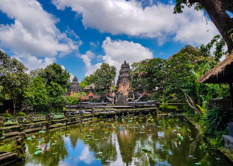Fototapeta na wymiar Saraswati Temple is a beautiful water palace surrounded with lotus flowers in a pond in Ubud, Bali, Indonesia.