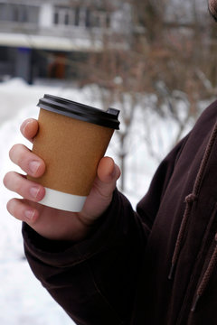 Close Up Man Keep Coffee Cup Behind Winter Landscape. Coffee To Go