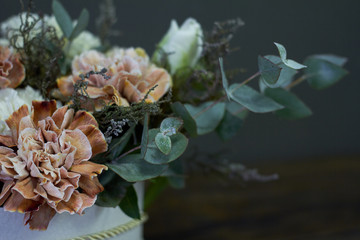 A box with a vintage bouquet on a dark background, selective focus