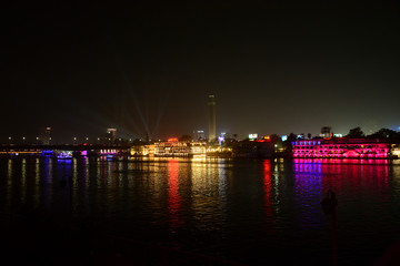 Beautiful view of river nile during night in Cairo Egypt showing light reflection from surrounding buildings and bouts