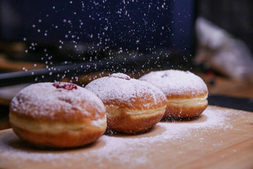 Hanukkah food doughnuts with jelly and sugar powder with bookeh background. Jewish holiday Hanukkah concept and background. Copy space for text. Shallow DOF