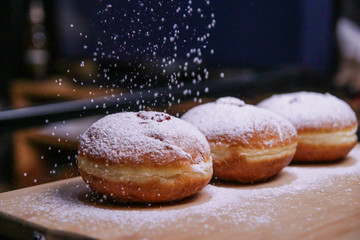 Hanukkah food doughnuts with jelly and sugar powder with bookeh background. Jewish holiday Hanukkah concept and background. Copy space for text. Shallow DOF