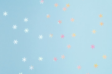 Fototapeta na wymiar Christmas flat lay, snowball confetti on light blue background