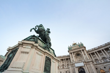 Hofburg palace, on its Neue Burg aisle, taken from the Heldenplatz square, with the 19th century Prinz Eugen statue in front in Vienna, Austria. It is the former Austro Hungarian imperial palace