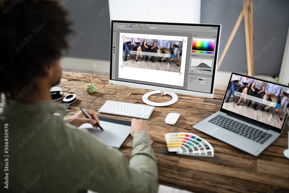 Poster Designer Editing Photo On Computer