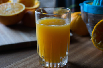 Orange juice on a table and juicer
