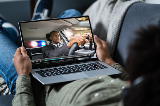 Man Watching Thriller Movie On Laptop