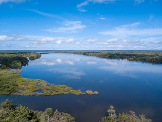 Drone aerial view of beautiful Xingu River on sunny summer day with blue sky in the Amazon rainforest, Mato Grosso, Brazil. Nature, ecology, natural resources, conservation and environment concept.