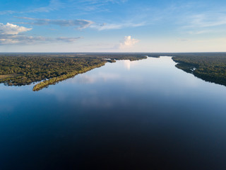 Beautiful aerial drone view of Xingu river in the Amazon rainforest on sunny summer day with blue...