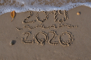 2019/2020 numbers written on the sand