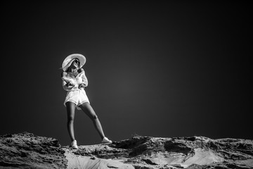 attractive girl in white stands on the beach