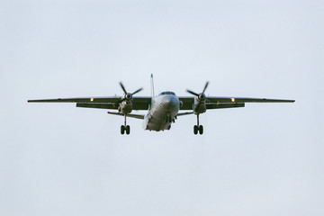 Freight military plane in the clear sky at evening time.