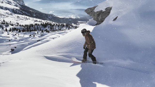 A girl is snowboarding in the backcountry during the winter in Swiss Alps. Shot in 4k with a gimbal.