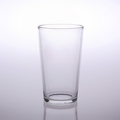 Empty glass isolated on grey and white background