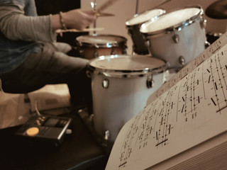 musician drummer practice with notes in the studio