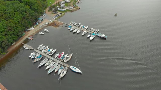 Aerial view on a yaght and boats parking in a calm bay