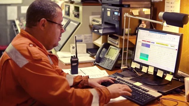 Marine engineer officer in engine control room ECR. Seamen's work. He works on the computer