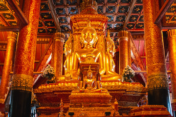 Four large stucco Buddha statues Turned the parson (back) colliding with his face towards the four directions At Phumin temple, Nan, Thailand