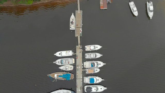 Aerial view on a yaght and boats parking in a calm bay