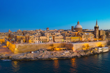 Valletta - capital of Malta. Aerial view, sunset, evening, church, blue sky and sea