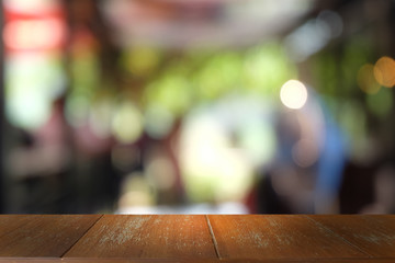 Empty dark wooden table in front of abstract blurred bokeh background of restaurant . can be used for display or montage your products.Mock up for space.