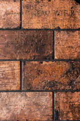 Vintage brick wall background texture of interior tiles . Wallpaper pattern with American city names on it. 