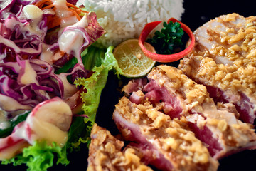 Grilled tuna steak with rice and vegetables. Close up.