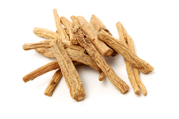 Dried medicinal herbs raw materials isolated on white. Root of Taraxacum, known as dandelions