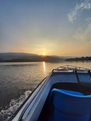 Obraz na płótnie Canvas boat on lake at sunset