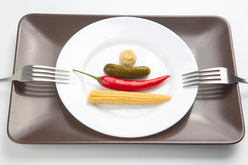 salad of canned and pickled mushrooms, corn, cucumber and red pepper on a white plate.  food and vegetables. diet and weight loss