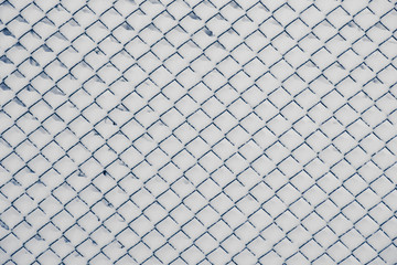 Chain link fence with snow on sunny winter day