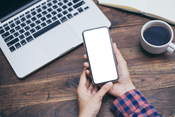 Mockup image blank white screen cell phone.men hand holding texting using mobile background empty space for advertise text.people contact marketing business and technology 