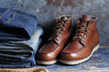 Safety shoes and old blue jeans on rustic background, Safety shoes and old blue jeans in a store