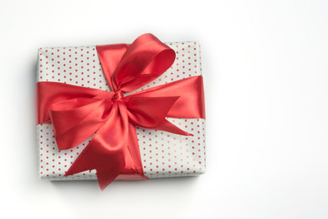 White polka dot gift box with red cute bow. Isolate background with copy space