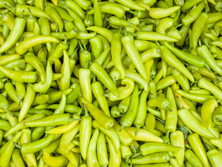 A pile of green banana peppers.