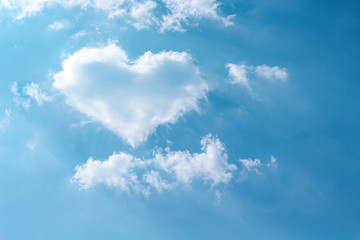 Clouds heart shaped patterns on bright blue sky with mild wind and reflection light from the sun...