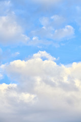 Beautiful blue sky with clouds on a bright day. Vertical photography