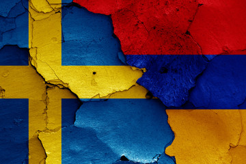 flags of Sweden and Armenia painted on cracked wall