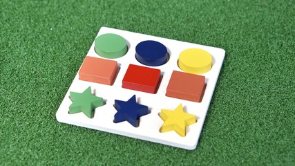 Colorful wood block toy on green grass