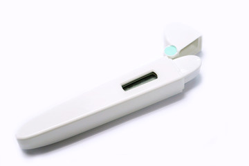 Medical thermometer in casing on white background.