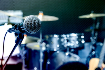Professional condenser studio microphone, Musical Concept. recording, selective focus  microphone in radio studio, selective focus microphone and blur musical equipment guitar